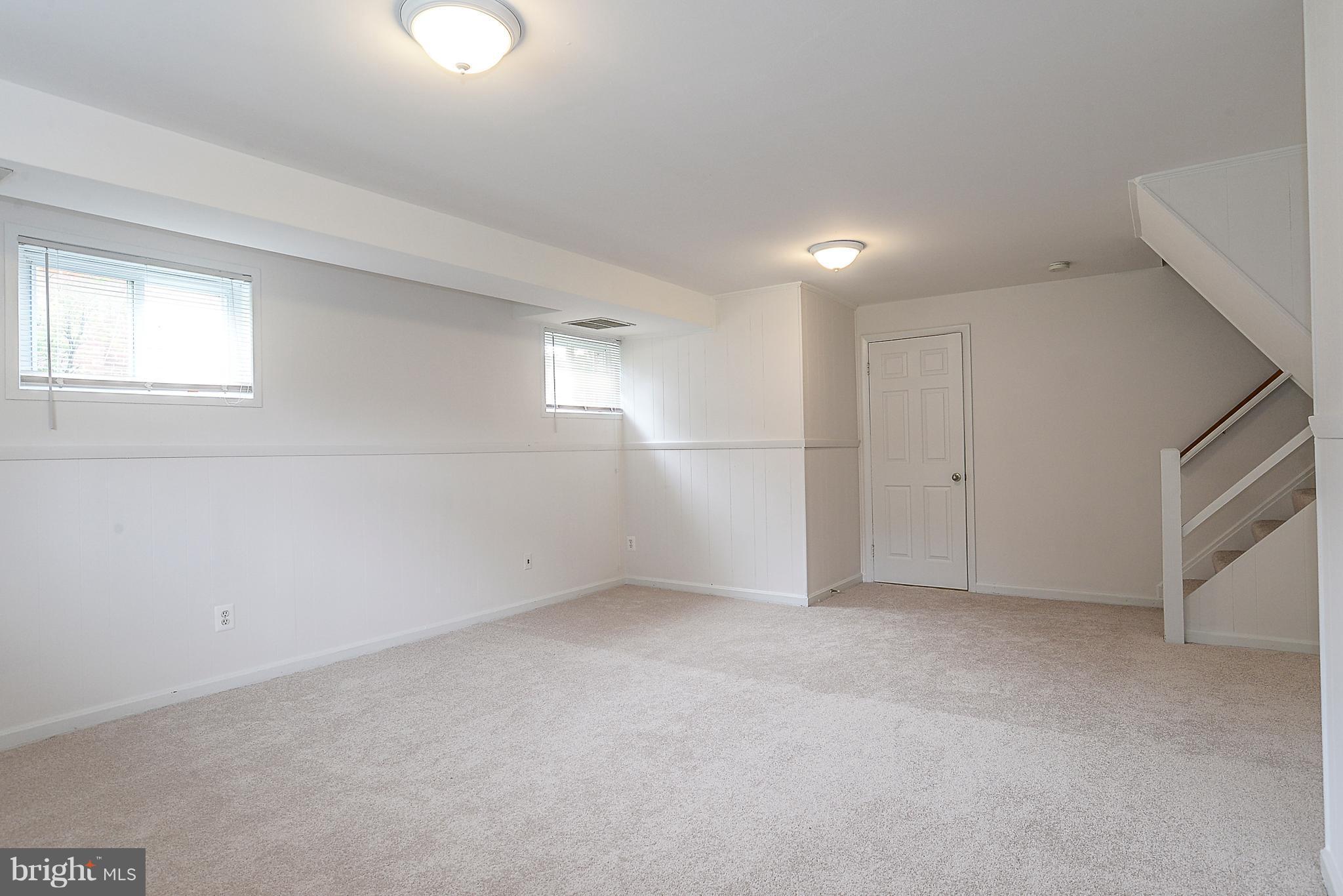 7106 Reservoir Road Springfield, VA 22150 - Photo 15 of 18 an empty room with white cabinet and windows