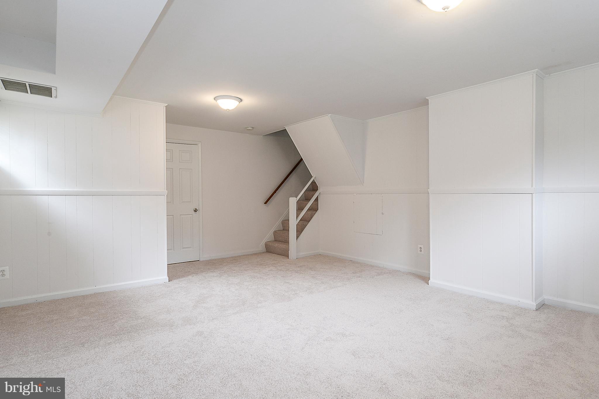 7106 Reservoir Road Springfield, VA 22150 - Photo 16 of 18 a view of an empty room with stairs