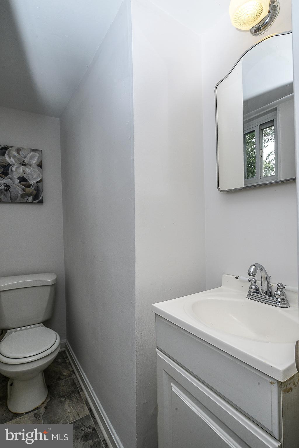 7106 Reservoir Road Springfield, VA 22150 - Photo 17 of 18 a bathroom with a toilet sink and mirror