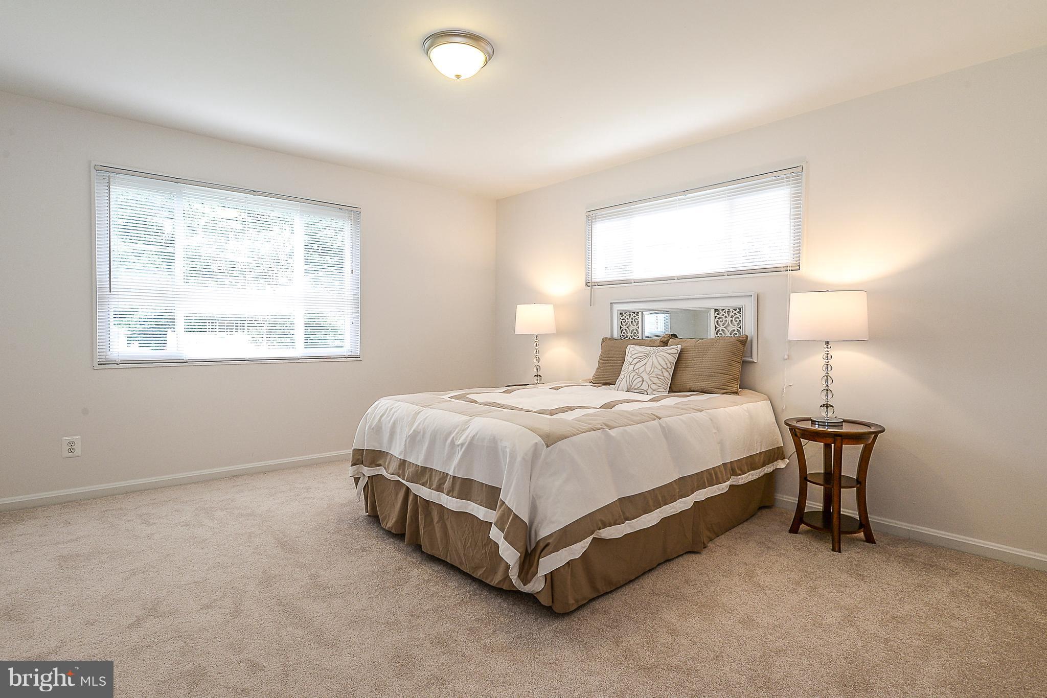 7106 Reservoir Road Springfield, VA 22150 - Photo 8 of 18 a spacious bedroom with a bed and a window