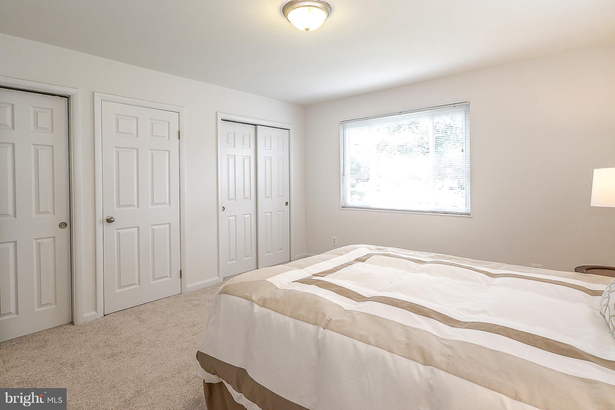 7106 Reservoir Road Springfield, VA 22150 - Photo 9 of 18 a spacious bedroom with a bed and a window