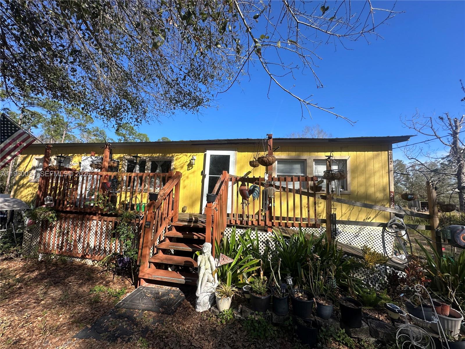 212 Ballard Road Avon Park, FL 33825 - Photo 2 of 61 a view of entryway with a floor to ceiling window and potted plants