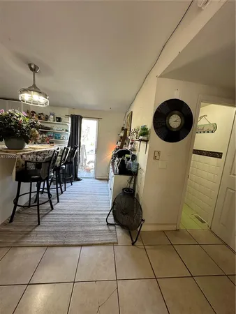 a kitchen with granite countertop a refrigerator and a counter top space