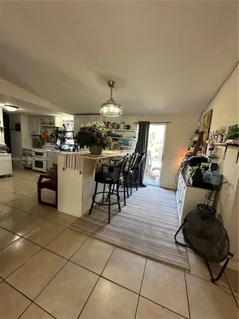 a kitchen with stainless steel appliances kitchen island granite countertop a refrigerator and a stove