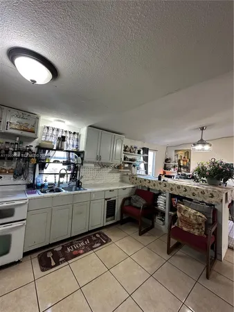 a living room with couches a computer on desk and chair