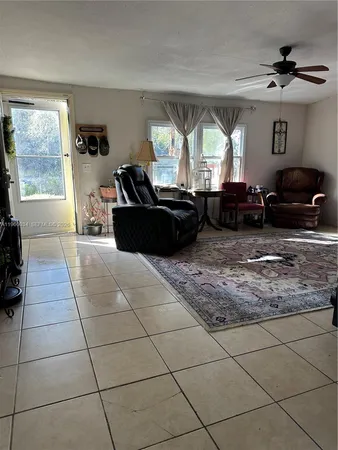 a living room with furniture chess board and a fireplace