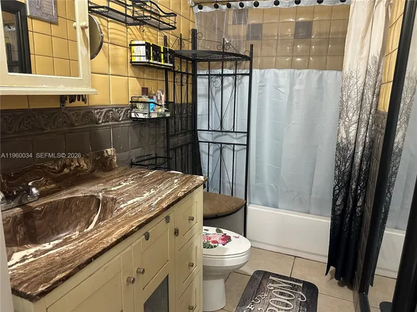 a bathroom with a sink a toilet a shower and a mirror