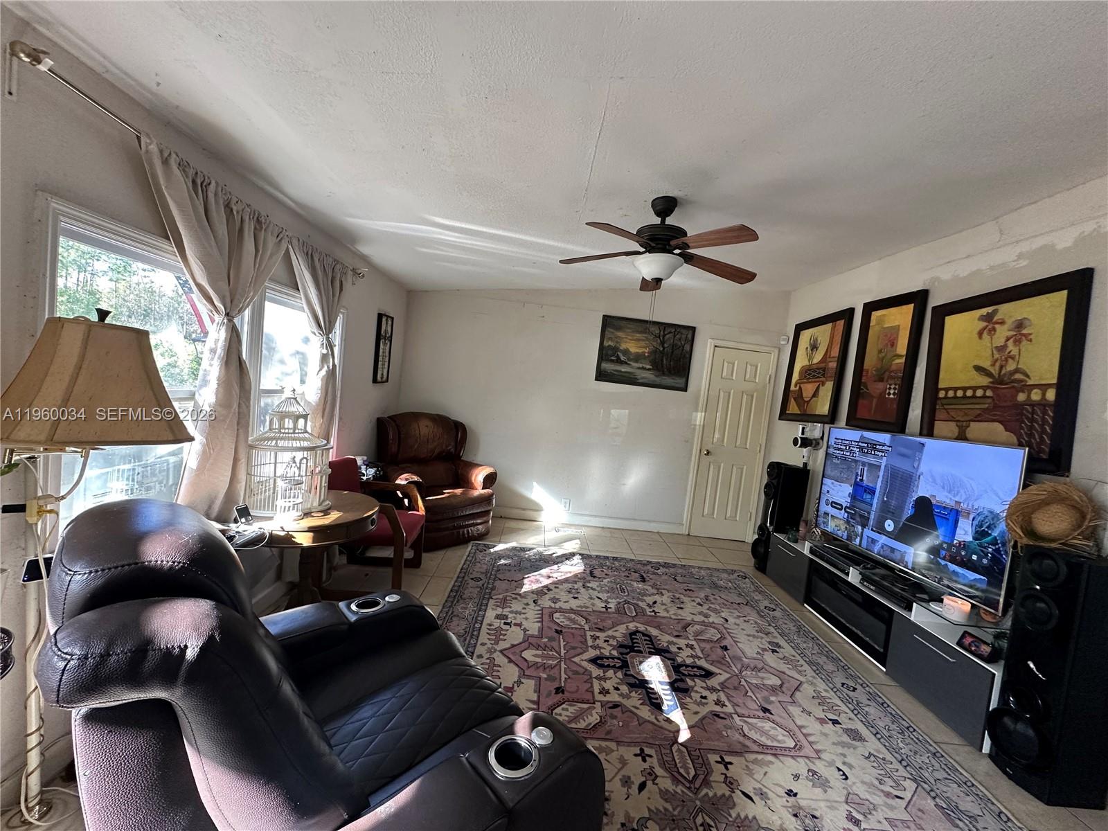 212 Ballard Road Avon Park, FL 33825 - Photo 59 of 61 a living room with furniture a window and a flat screen tv