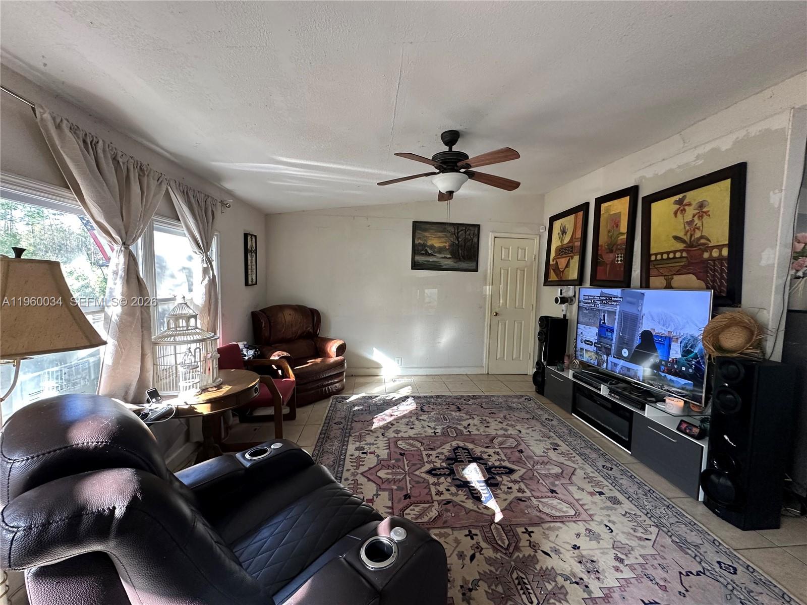 212 Ballard Road Avon Park, FL 33825 - Photo 60 of 61 a living room with furniture and a flat screen tv