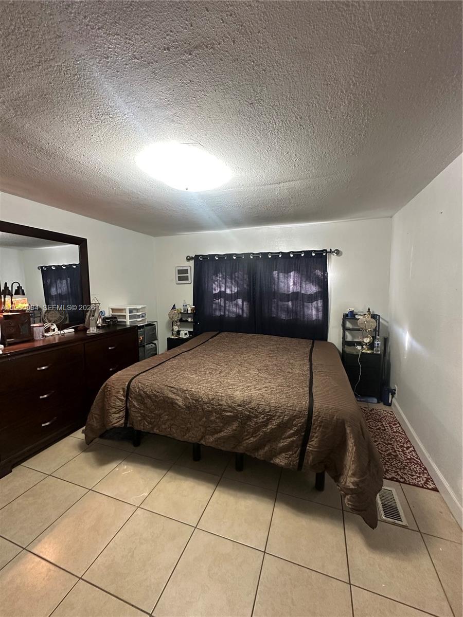 212 Ballard Road Avon Park, FL 33825 - Photo 10 of 61 a bedroom with a bed and a dresser