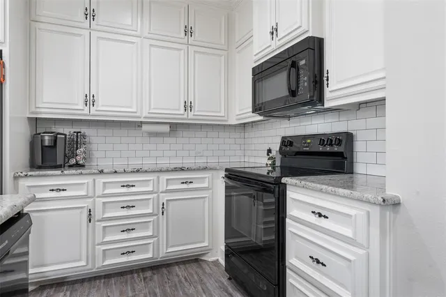 a kitchen with cabinets stainless steel appliances and a sink
