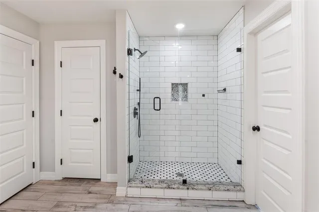 a bathroom with a glass shower door