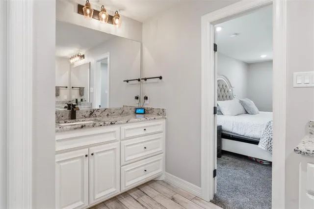 a en suite bathroom with a double sink and mirror
