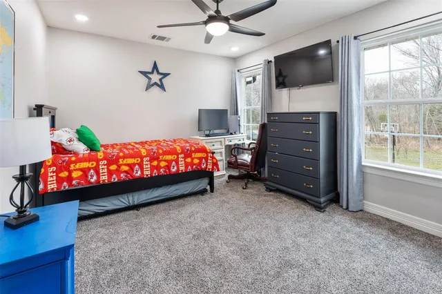 a room with a bed and a flat screen tv