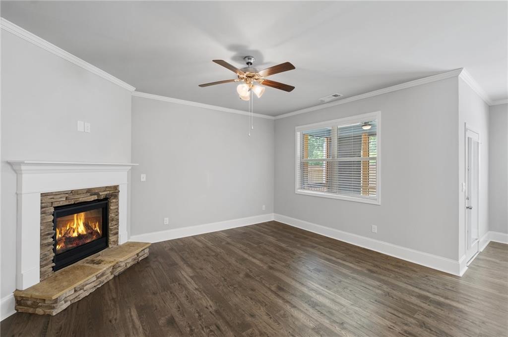 75 South Cornucopia Bend Dallas, GA 30132 - Photo 11 of 35 a view of an empty room with chandelier fan and fire place