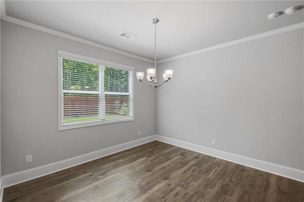 75 South Cornucopia Bend Dallas, GA 30132 - Photo 13 of 35 a view of a room with wooden floor ceiling fan and windows