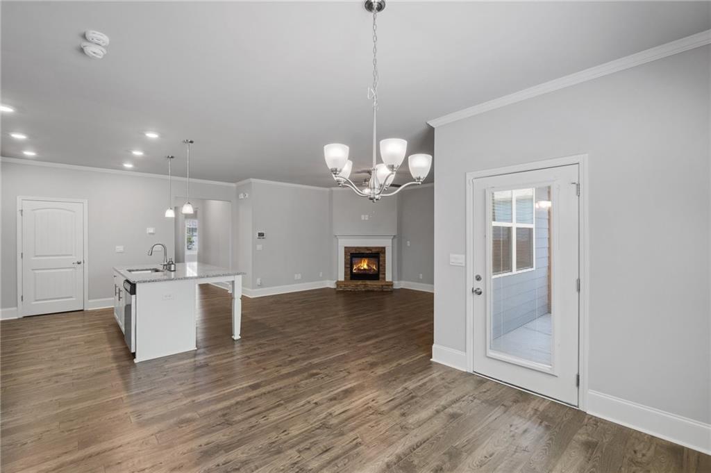 75 South Cornucopia Bend Dallas, GA 30132 - Photo 14 of 35 a view of a livingroom with a kitchen and a chandelier wooden floor