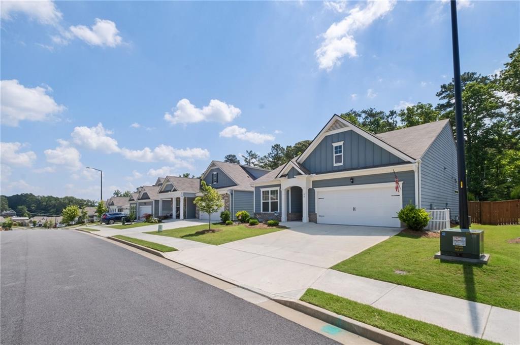 75 South Cornucopia Bend Dallas, GA 30132 - Photo 2 of 35 a front view of a house with a garden and yard