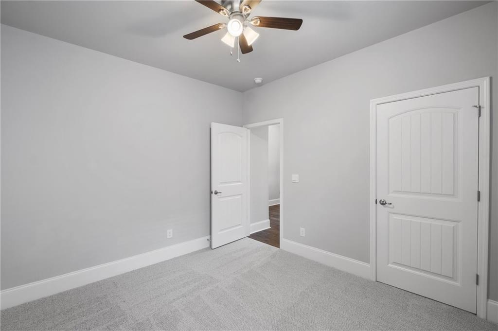 75 South Cornucopia Bend Dallas, GA 30132 - Photo 25 of 35 an empty room with chandelier fan and windows