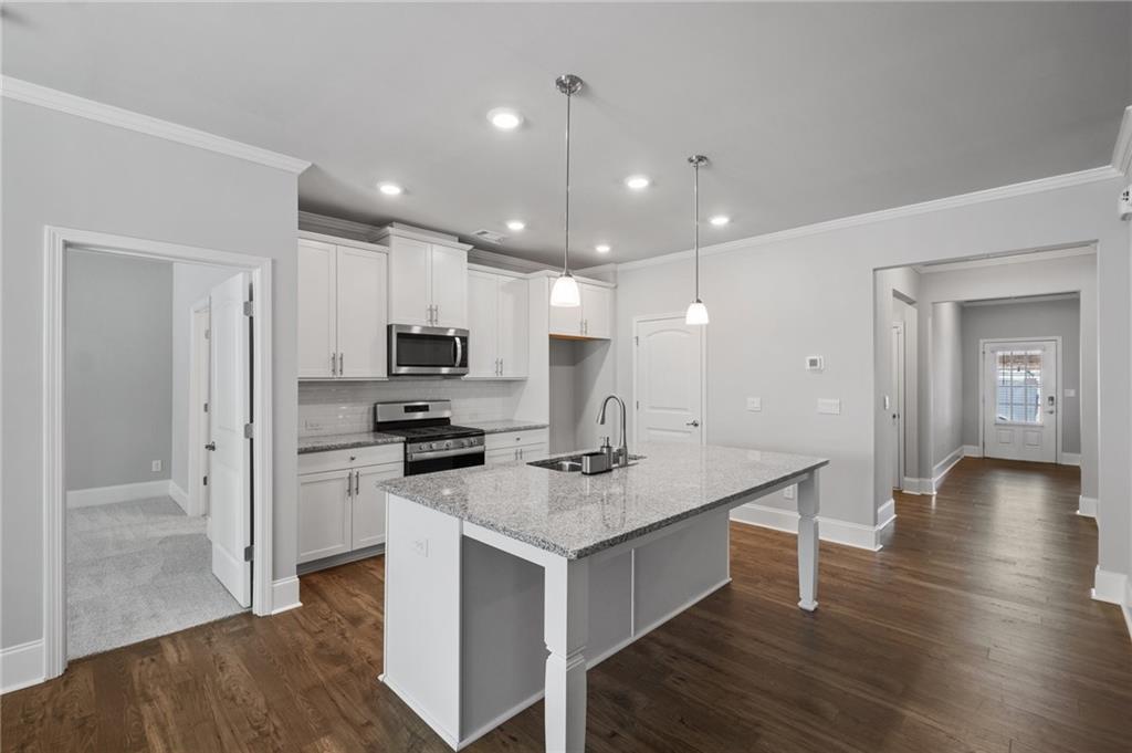75 South Cornucopia Bend Dallas, GA 30132 - Photo 6 of 35 a kitchen with a sink a counter top space and stainless steel appliances