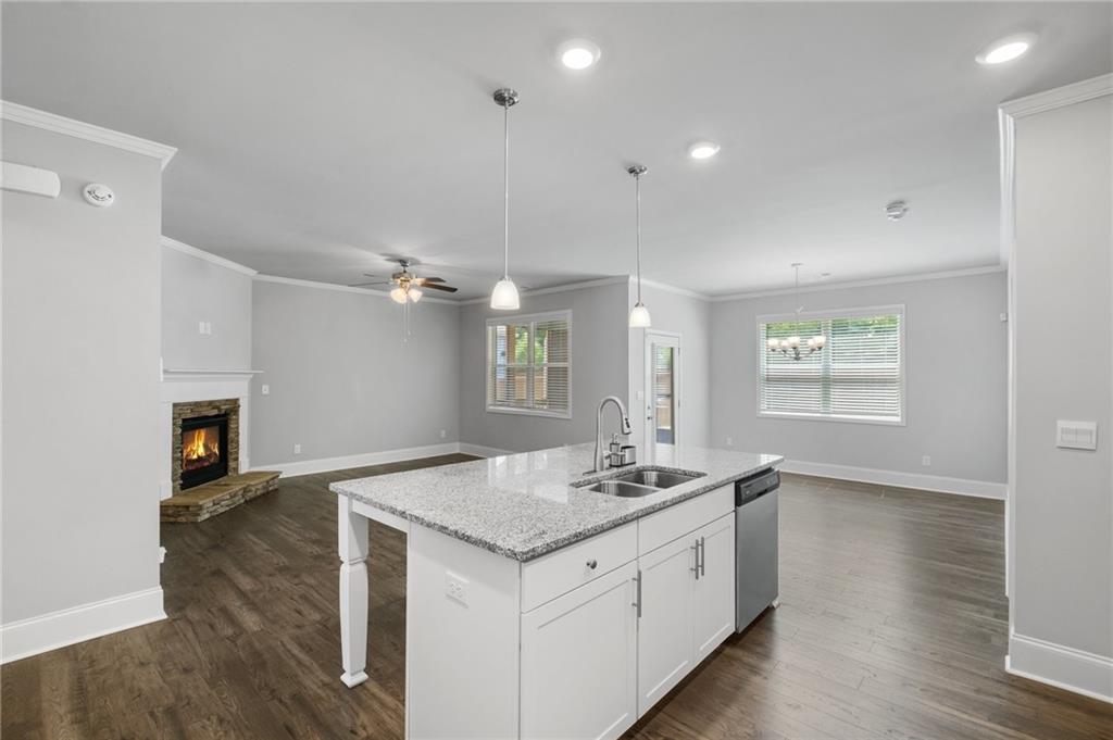 75 South Cornucopia Bend Dallas, GA 30132 - Photo 7 of 35 a hall with kitchen island a stove a wooden floor and a sink