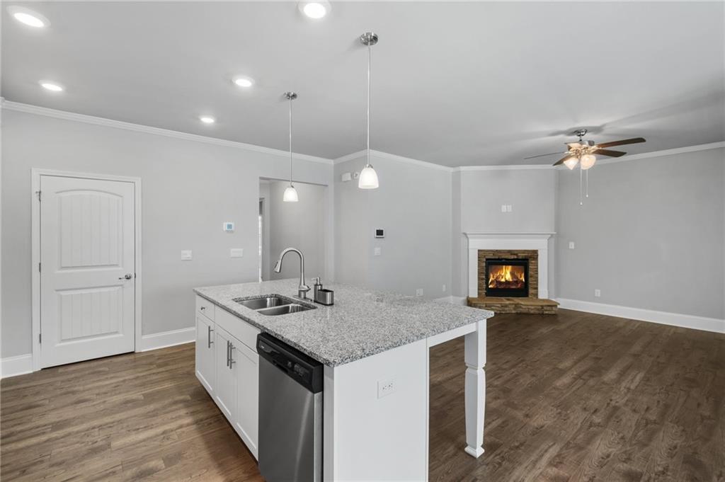 75 South Cornucopia Bend Dallas, GA 30132 - Photo 8 of 35 a kitchen with a sink a counter space and a fireplace