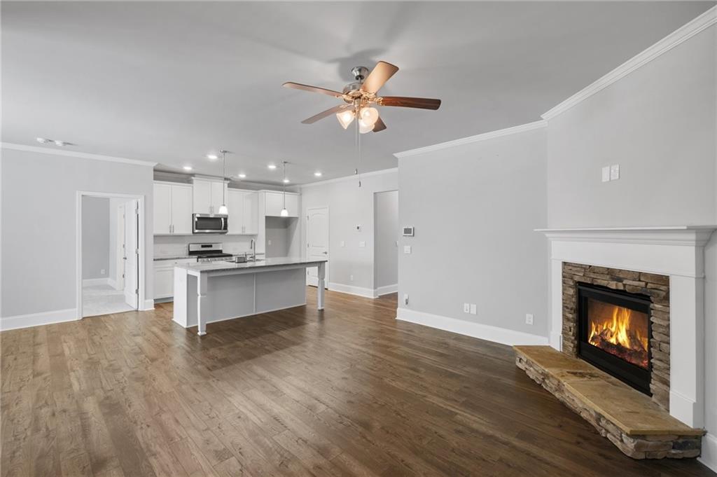 75 South Cornucopia Bend Dallas, GA 30132 - Photo 10 of 35 a large kitchen with cabinets a fireplace and a ceiling fan