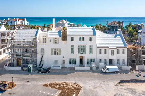 a view of a building with cars parked