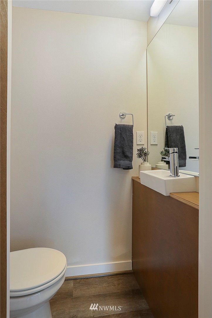 6241 8th Avenue Northwest Seattle, WA 98107 - Photo 14 of 27 a bathroom with a toilet a sink and mirror