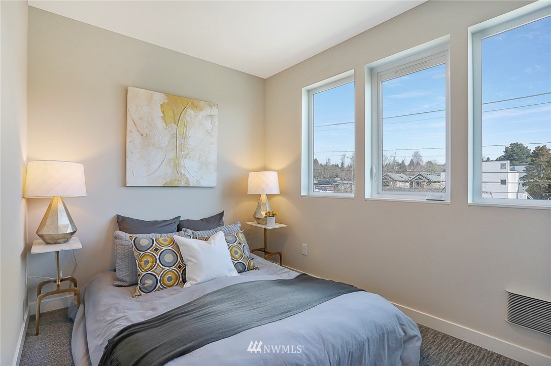 6241 8th Avenue Northwest Seattle, WA 98107 - Photo 15 of 27 a bedroom with a bed and a lamp next to a window