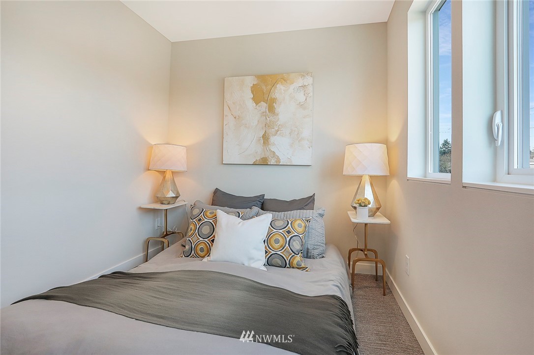 6241 8th Avenue Northwest Seattle, WA 98107 - Photo 16 of 27 a bedroom with a bed and a lamp on table