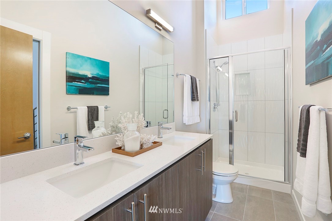 6241 8th Avenue Northwest Seattle, WA 98107 - Photo 20 of 27 a bathroom with double sink and a mirror