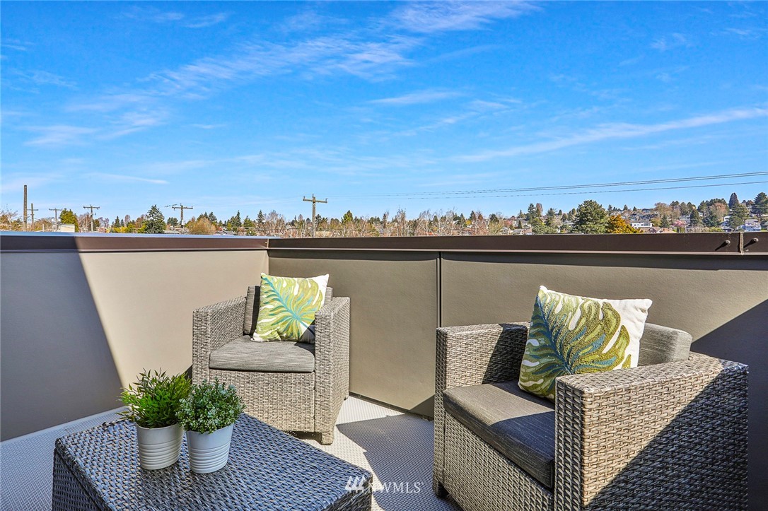 6241 8th Avenue Northwest Seattle, WA 98107 - Photo 22 of 27 a balcony with furniture and a potted plant