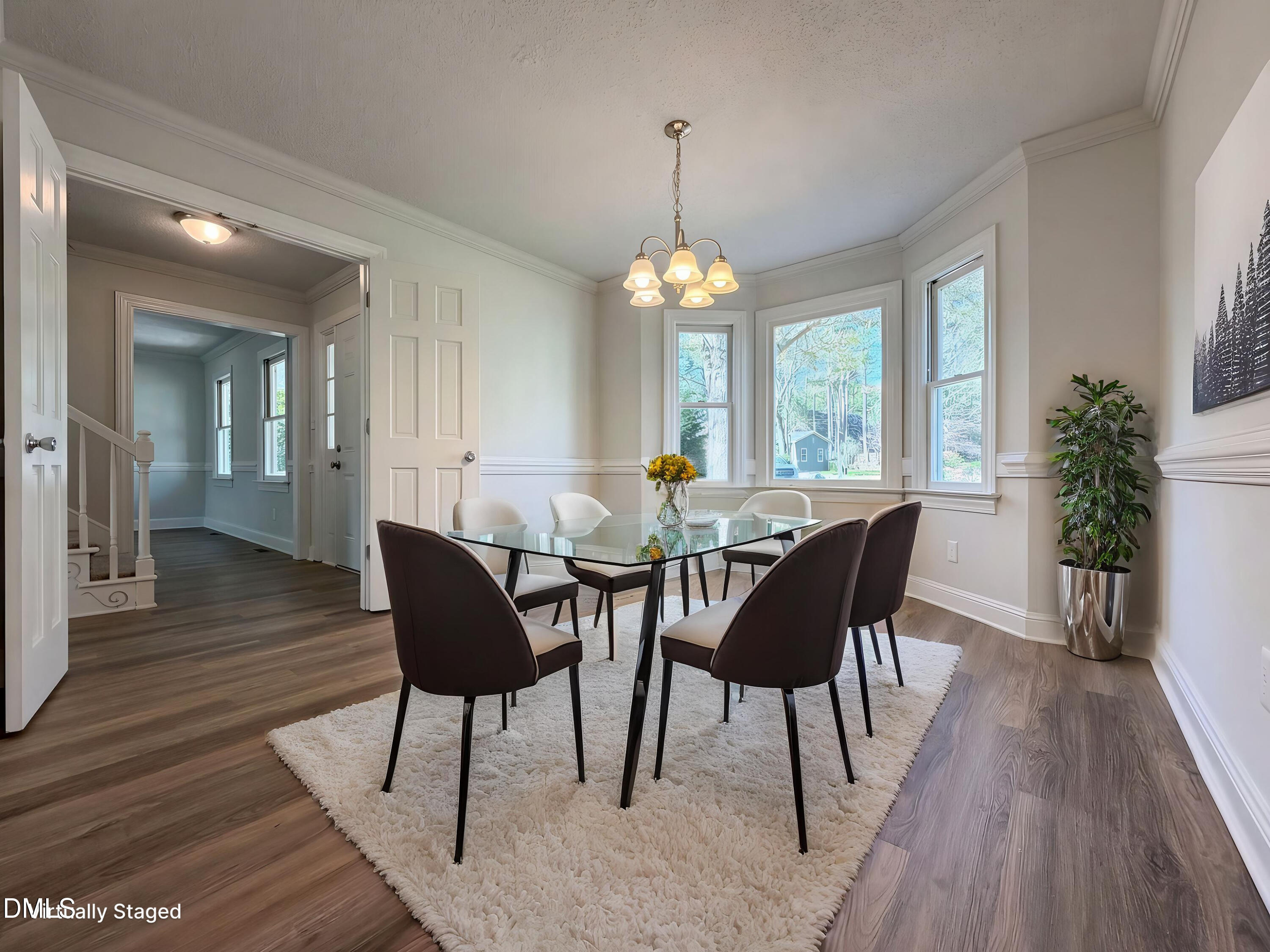 8612 Clovehitch Court Raleigh, NC 27615 - Photo 11 of 25 a view of a dining room with furniture window and wooden floor