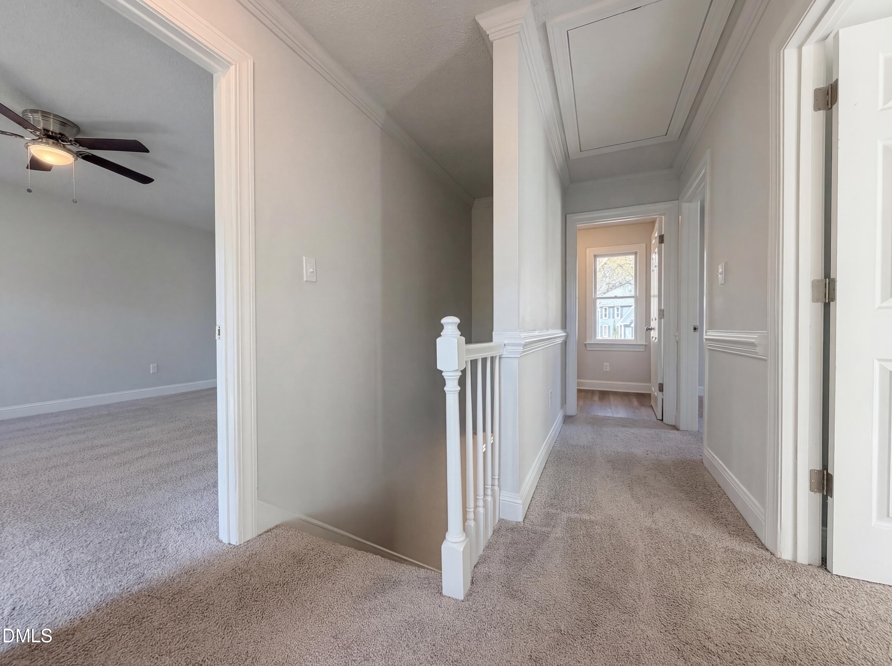 8612 Clovehitch Court Raleigh, NC 27615 - Photo 13 of 25 a view of a hallway to closet and wooden floor
