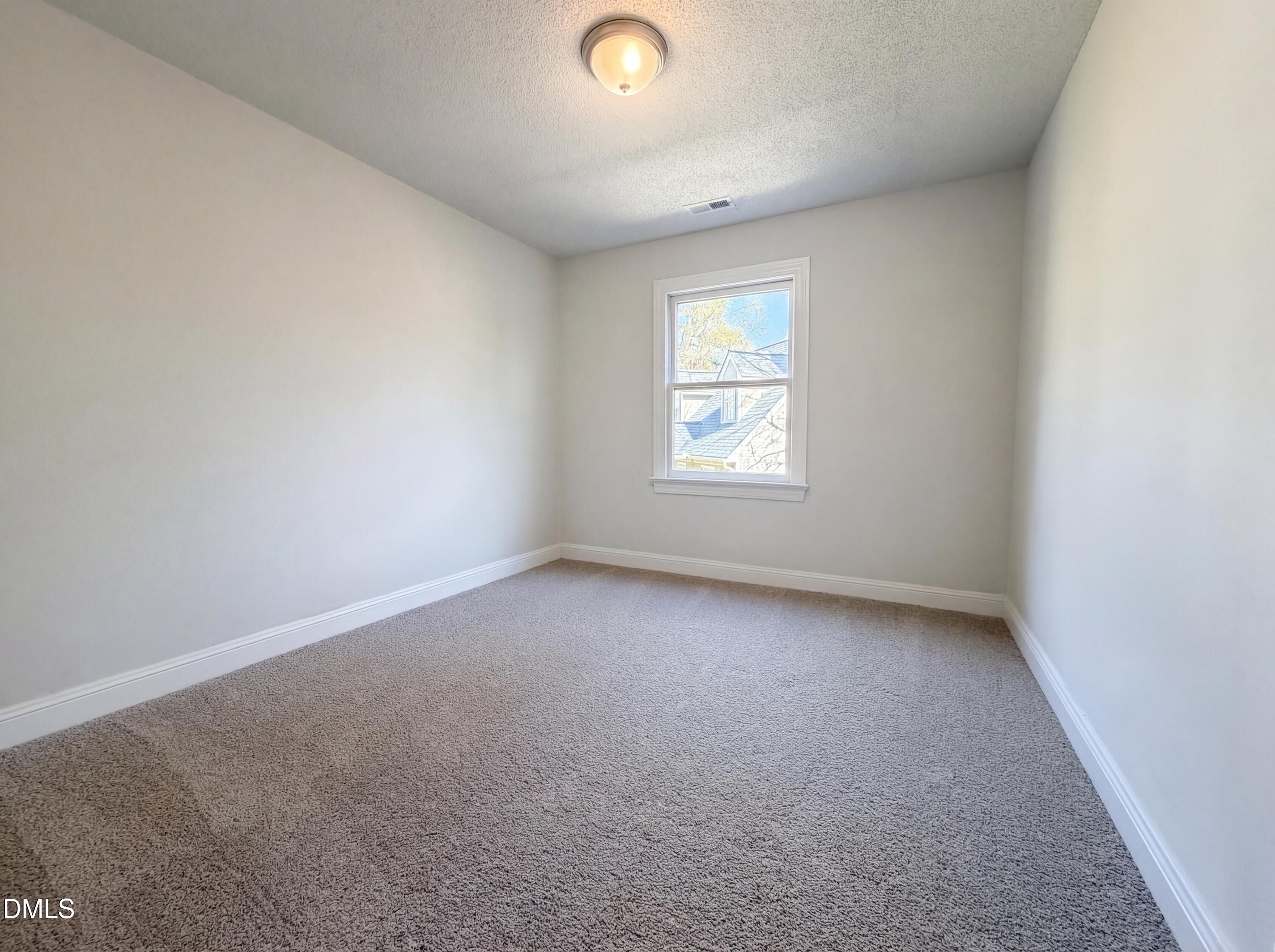 8612 Clovehitch Court Raleigh, NC 27615 - Photo 15 of 25 an empty room with windows