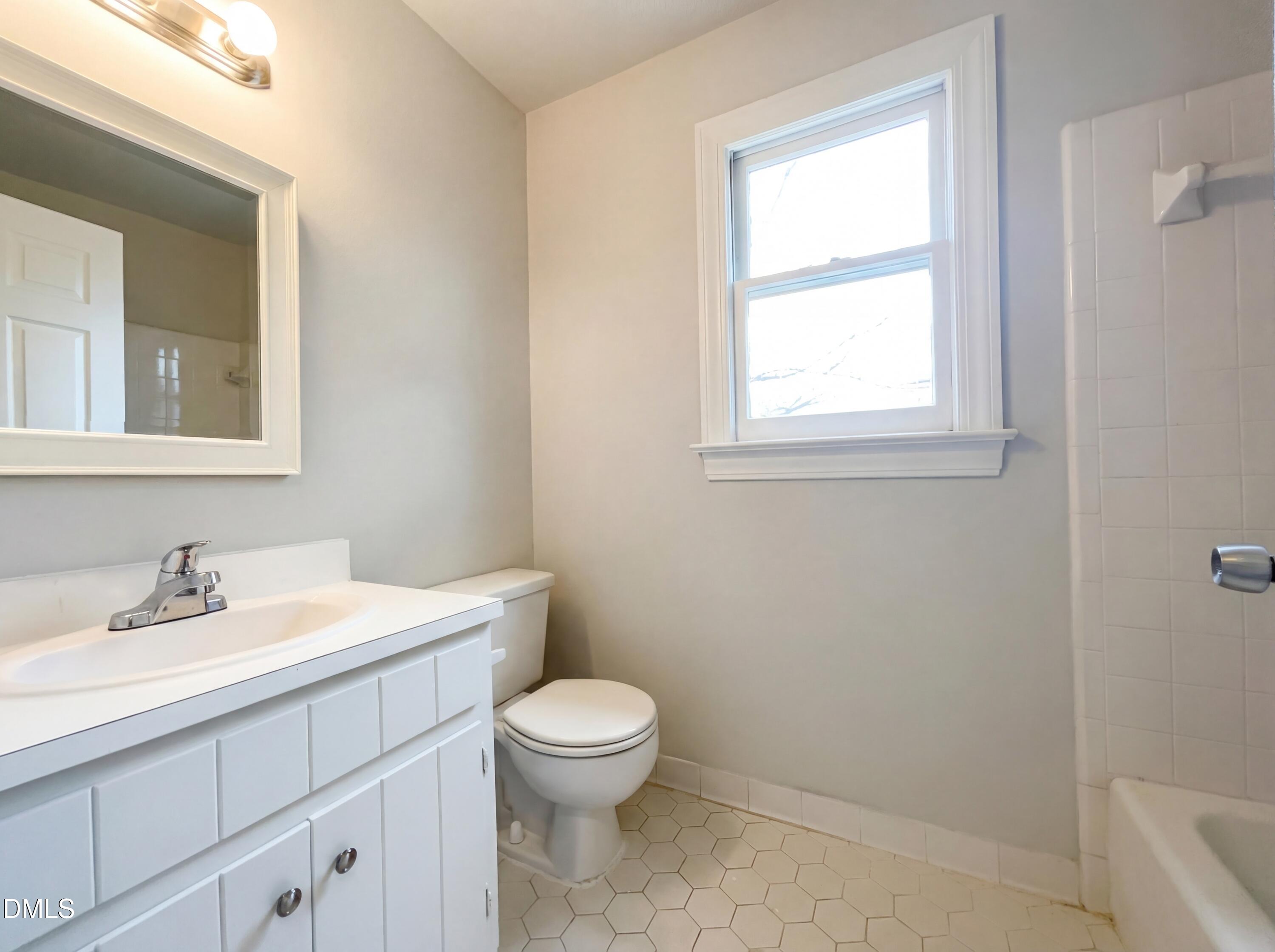 8612 Clovehitch Court Raleigh, NC 27615 - Photo 17 of 21 a bathroom with a toilet sink and mirror