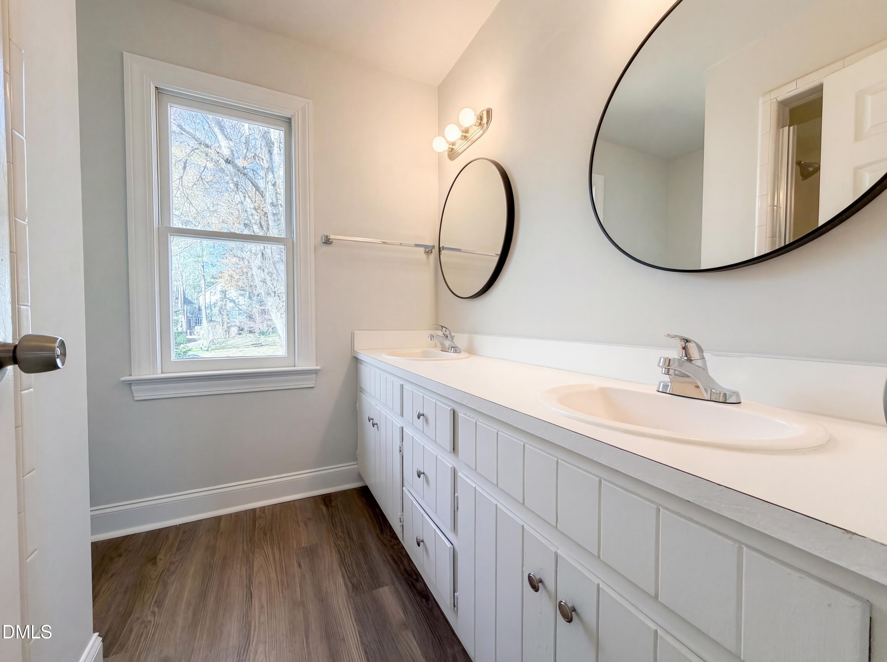8612 Clovehitch Court Raleigh, NC 27615 - Photo 20 of 25 a bathroom with a double vanity sink and a mirror