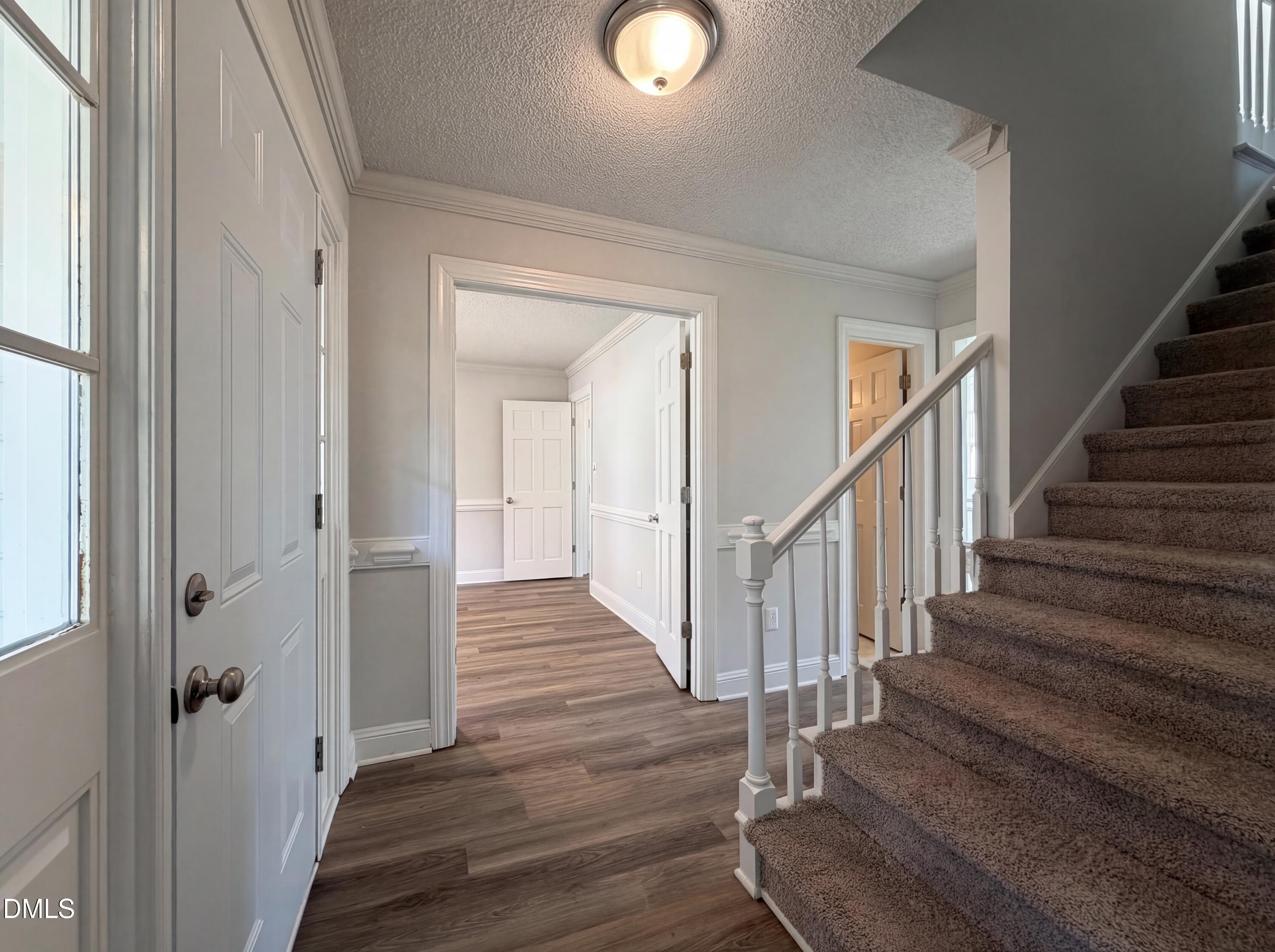 8612 Clovehitch Court Raleigh, NC 27615 - Photo 4 of 25 a view of a hallway with wooden floor and entryway