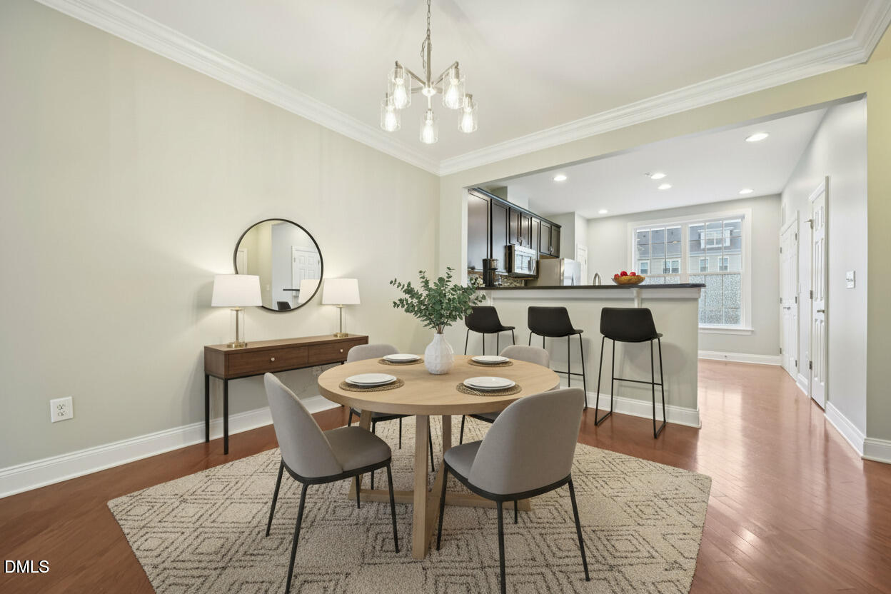 10510 Sablewood Drive, Unit 113 Raleigh, NC 27617 - Photo 10 of 38 a view of a dining room with furniture and wooden floor