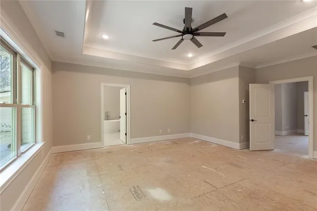 a spacious bathroom with a tub sink and mirror