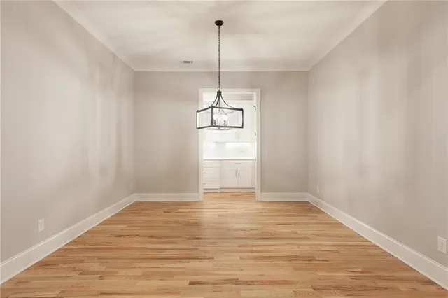 a large kitchen with stainless steel appliances a stove top oven and refrigerator