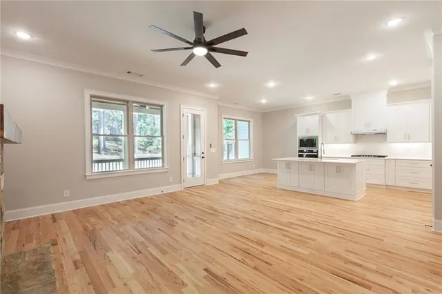 a living room with stainless steel appliances granite countertop a stove and a fireplace