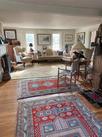 a view of a room with furniture and wooden floor