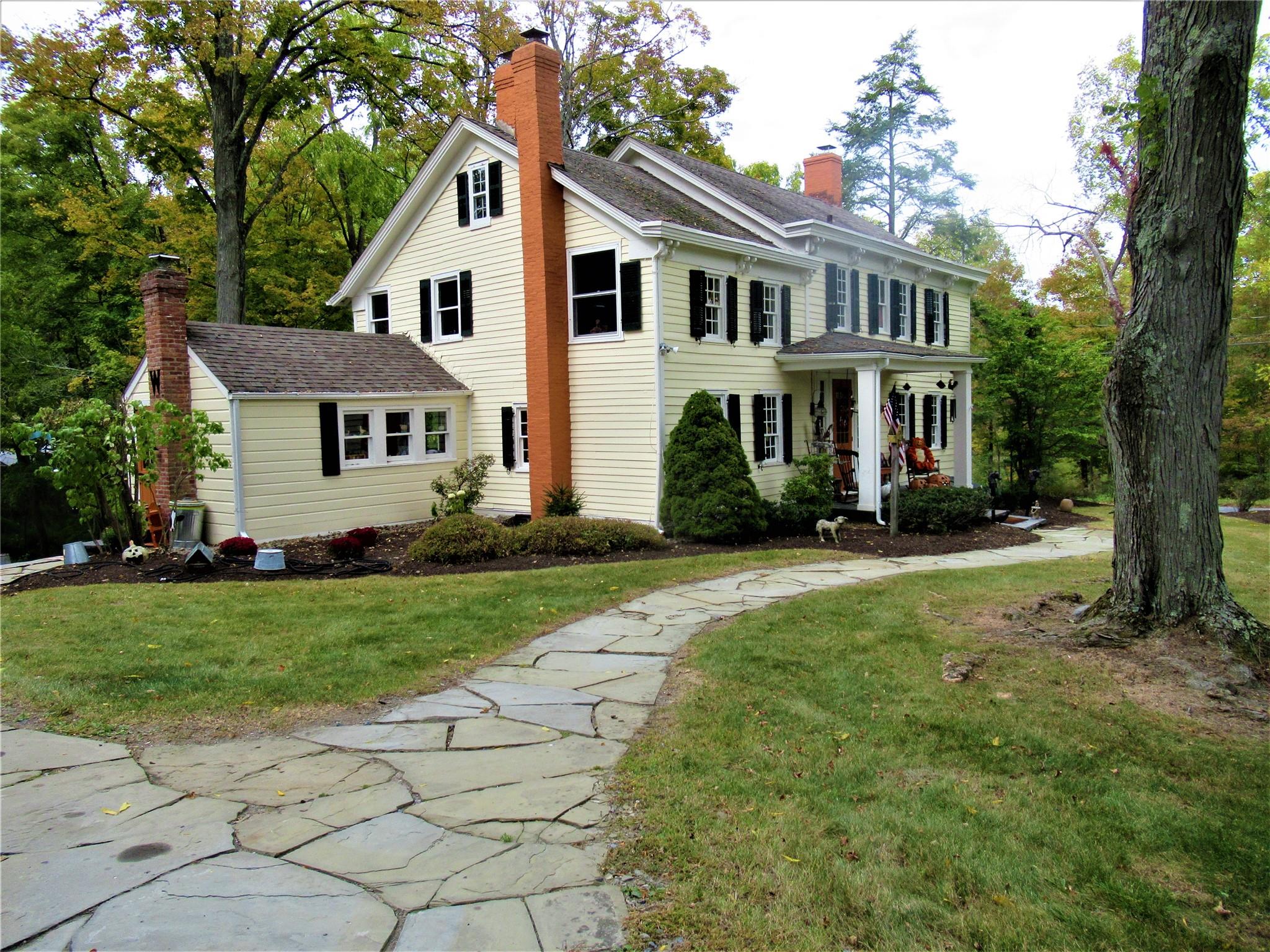 124 East Ridge Road Warwick, NY 10990 - Photo 3 of 46 a front view of a house with a garden