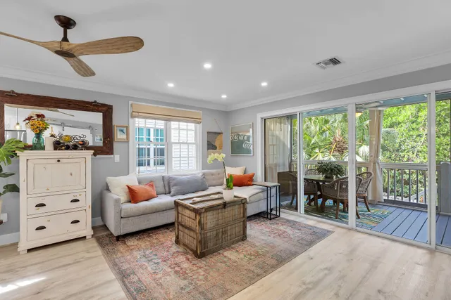 a living room with furniture and large windows
