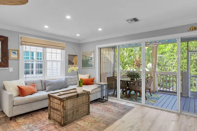 a living room with furniture and large windows