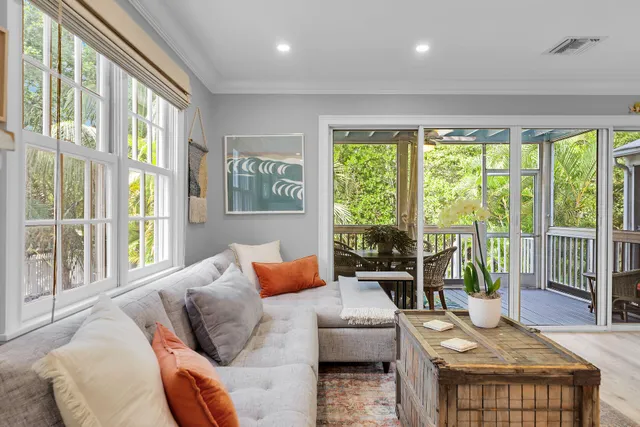 a living room with furniture and large windows
