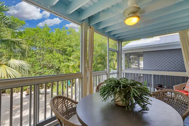 a balcony with table and chairs