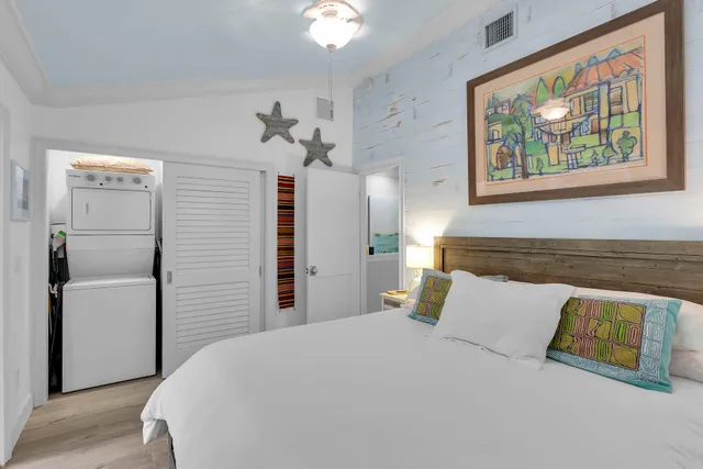 a bedroom with a bed and a painting on the wall